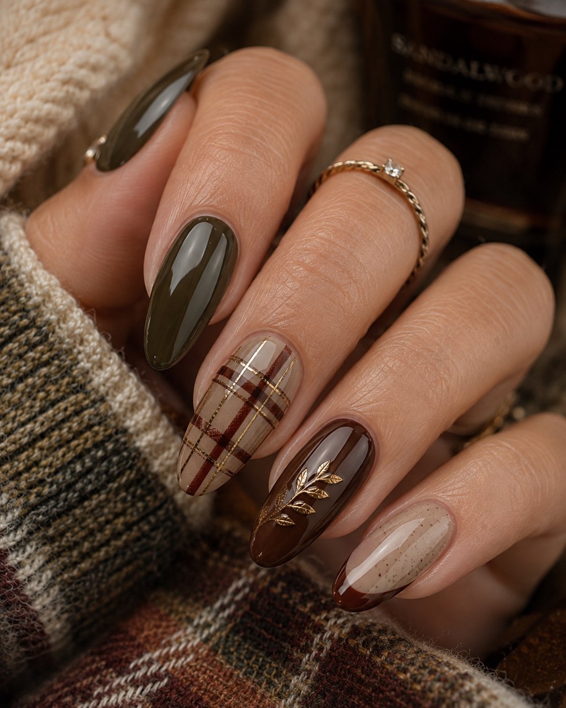 Long almond fall nails in olive, chocolate and cream plaid with gold leaf art