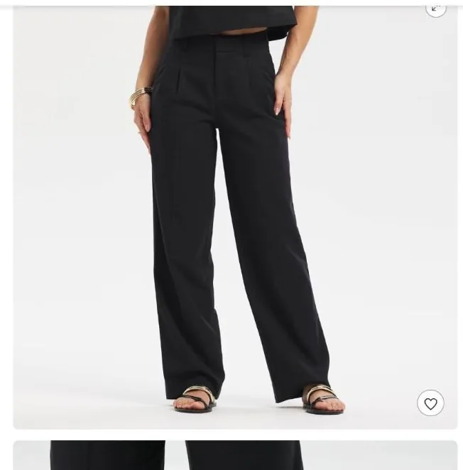 Black high-rise wide-leg trousers styled as the foundation piece for work, errands, and evening looks