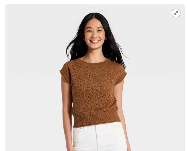 Brown cap sleeve knit sweater layered over the trousers for the work look
